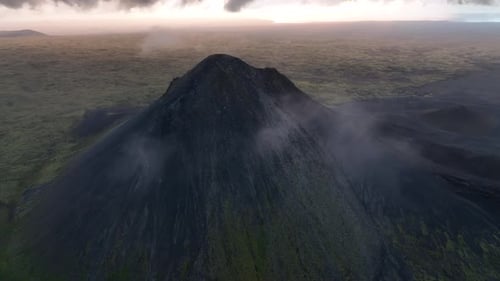 A panoramic shot across a field of rocks and moss-covered mountains