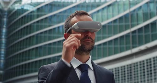 Adult Using VR Headset in Urban Environment