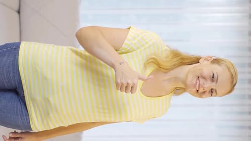 Smiling Woman Gives Thumbs Up and Waves