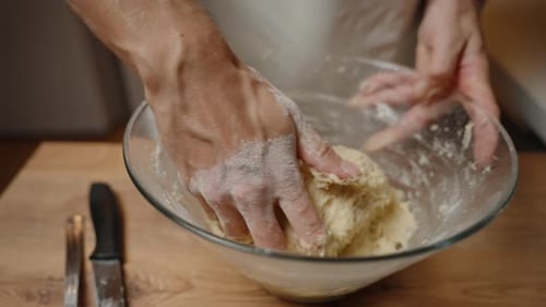 Mixing Dough in Bowl with Hands Close Up
