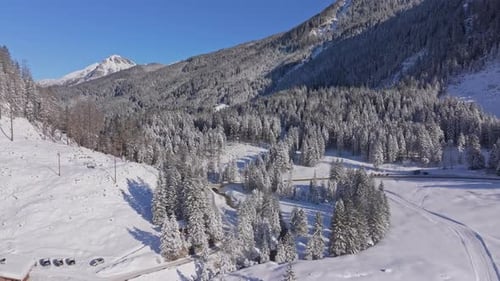 Aerial view of alpine restaurant beside snowy Nordic ski course in Austria