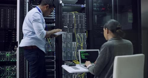 Technicians Working in Modern Server Room