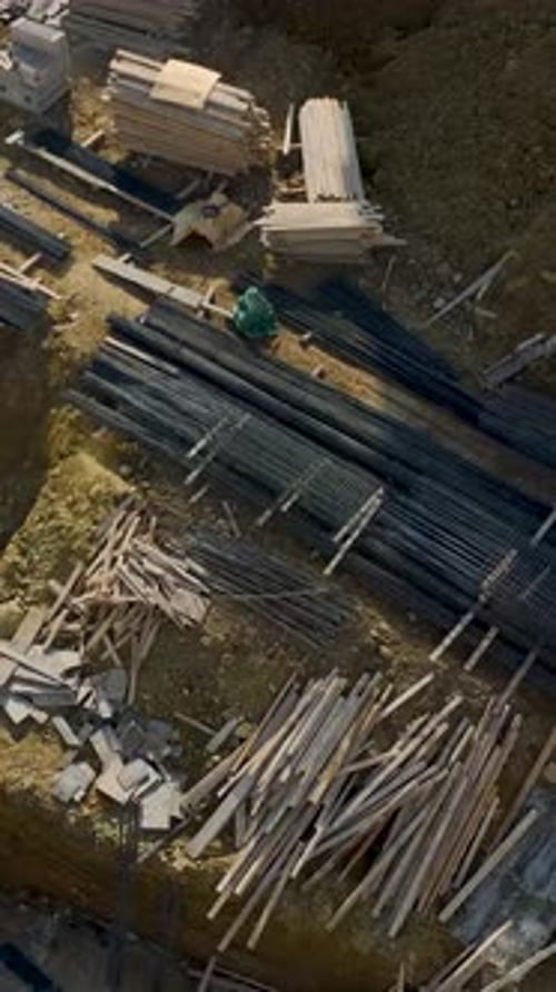 Vertical Drone Shot Top View Construction Site with Workers Positioned Across Sections
