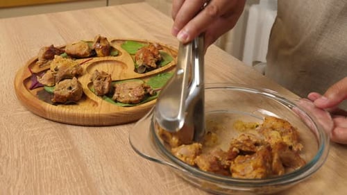 90. The meat is laid out on a wooden plate. Serving meat dishes.