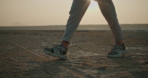 Low Angle Person Walking on Beach at Sunset