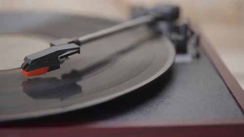 Close up Turning on and playing a Retro vinyl record playing spining.