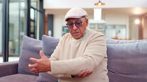 Senior Man Experiencing Arm Pain Indoors