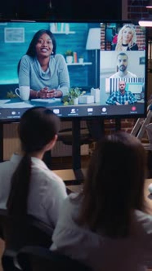 Two Women Watching a Corporate Video Conference