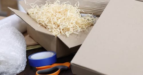 Different packaging materials on table indoors, closeup. Camera moving forward