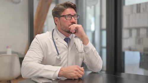 Young Doctor Brainstorming while sitting in Clinic