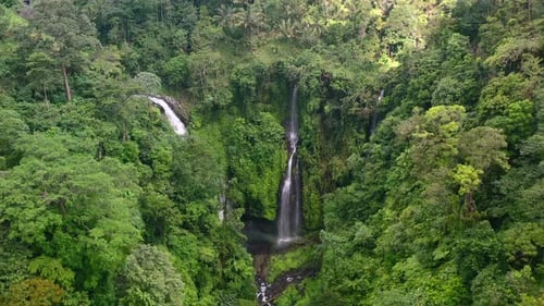aerial of two waterfalls hidden in the lush jungle of Bali Indonesia