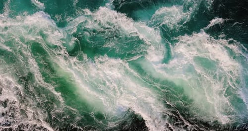 Blue waves of water of the river and the sea meet each other during high tide and low tide.