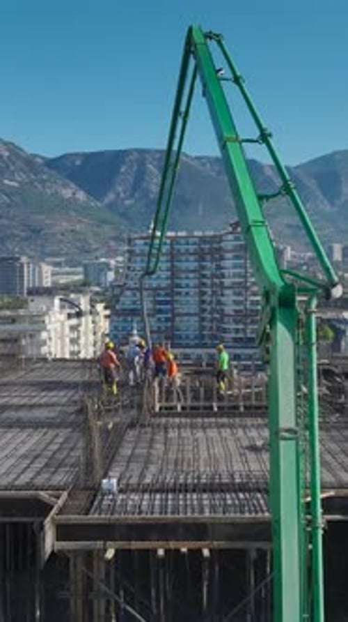 Vertical Video of Concrete Pouring and CraneAssisted Metalwork on a Residential Construction Project