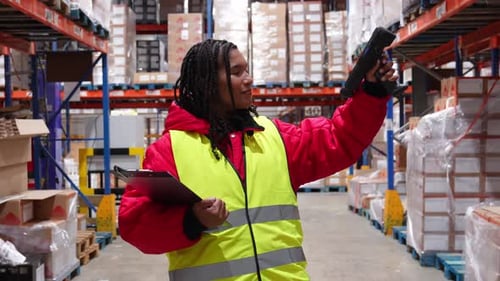 Female Warehouse Worker Scanning Barcodes in Cold Storage