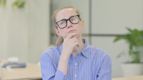 Woman Thinking Carefully in Office Setting