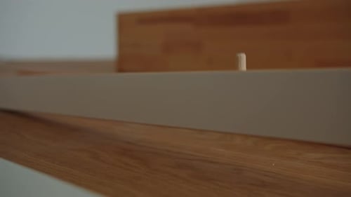 Insertion de chevilles en bois pour l'assemblage du cadre de lit dans une maison de meubles de chambre moderne