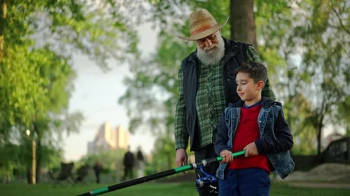 Grandfather and Child Fishing Together in Park