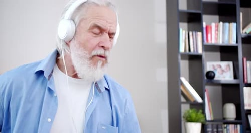 Senior Man Dancing with Headphones in Living Room