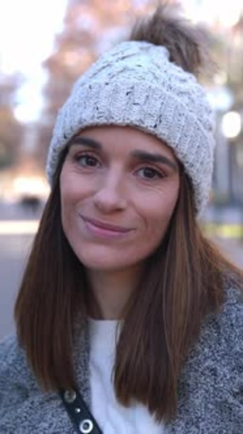 Cheerful Young Adult Woman Smiling at Camera Standing on Winter in City Street