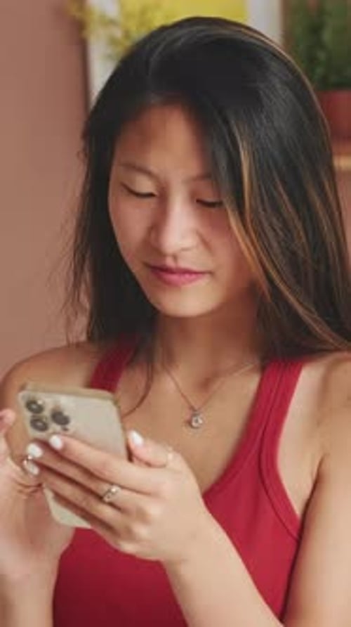 Young Adult Using a Smartphone Indoors