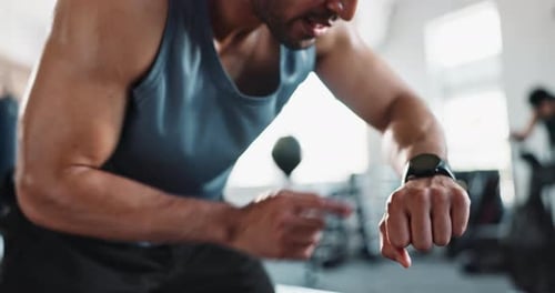 Man, sweat and smart watch in gym for fitness, exercise and break with challenge