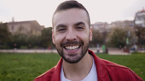 Happy Young Man Smiling at Camera Outdoors