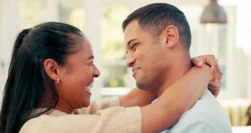 Smiling Couple Embracing in Bright Home Setting