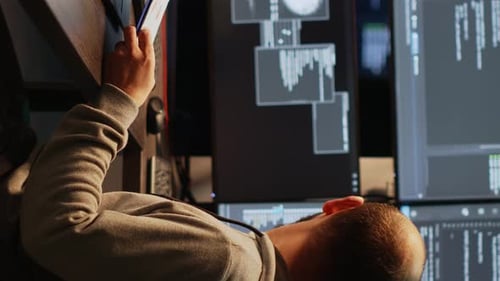 Vertical Video Male IT Engineer Analyzing Web Data on Clipboard Papers and Screens