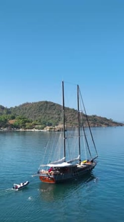 Sailing Boat Cruise Along Beautiful Coastline on Summer Day