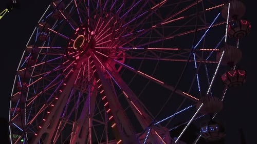 Ferris Wheel At Night In Amusement Park