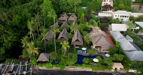 Tropical hotel location amidst island nature environment, aerial parallax