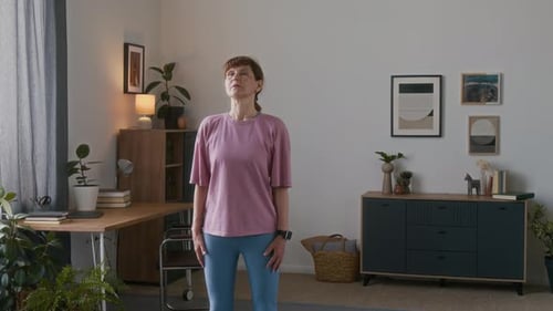 Woman Doing Neck Stretches in Her Home