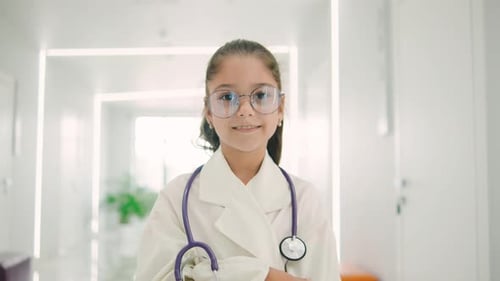 Smiling Girl Doctor in Bright Hospital Hallway