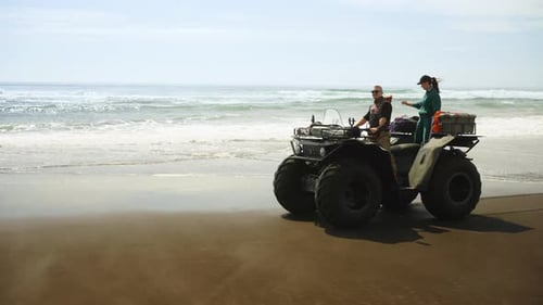 Tourists Enjoying Freedom And Beauty Of Nature On Coastline Of Ocean Or Sea Ride By Quad
