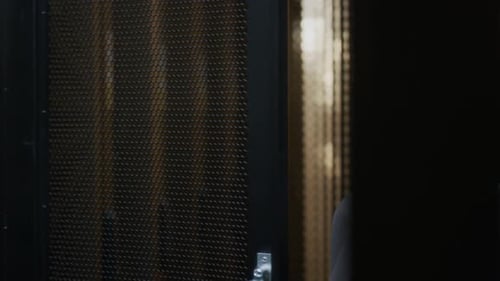 Young Confident Female IT Specialist Checking Mainframe Work in Data Center