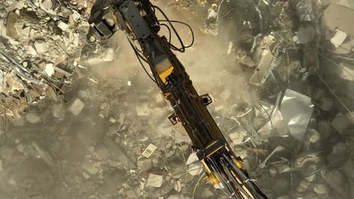 Excavator arm demolishing an old building, Aerial view