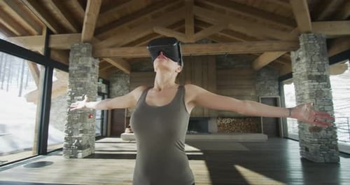 Woman Wearing VR Headset in Winter Cabin