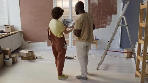 Married Couple Discussing Interior Design Ideas for Remodeling Room
