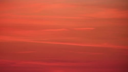 At dusk, the sunset bathed the cloudscape in a stunning red light, time lapse