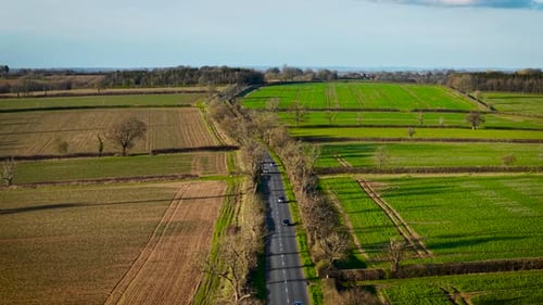 Cars Driving Along Countryside Road Vehicles Moving Through Rural Route