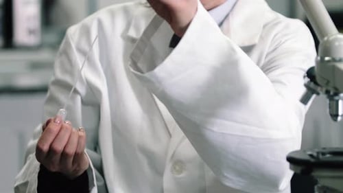 Woman Scientist Pipetting Liquid in Lab Close Up