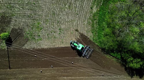 Aerial view of tractor tilling soil