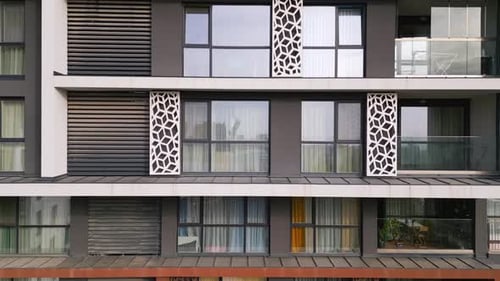 Aerial View of a Drone Flying Around and Along the Facade of a Modern Residential Building
