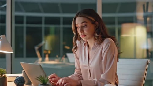 Woman Browsing Computer Overtime in Dark Office Exhausted Woman Closing Laptop