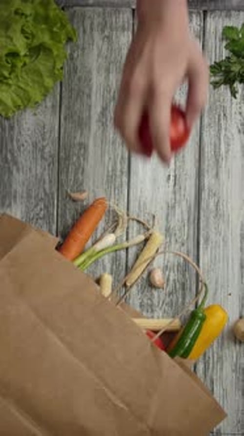 Vertical of Crop People Taking Groceries Out From Paper Bag