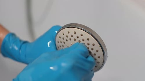 Close Up Cleaning a Shower Head