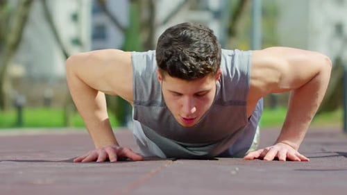 Strong Man Doing Push-Ups in Urban Setting