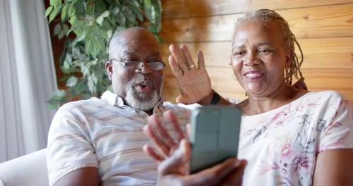 Senior Couple Waving During a Video Call