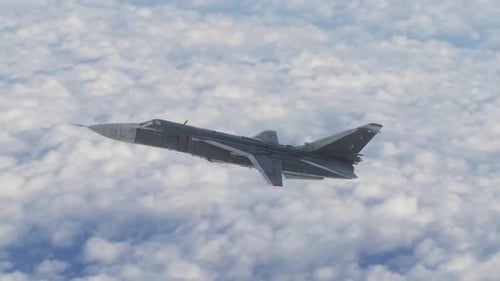 Modern Fighter Jet Soaring Above Clouds