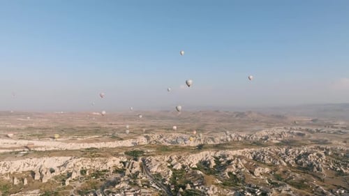 Hot Air Balloons Float Over Cappadocia Landscape
